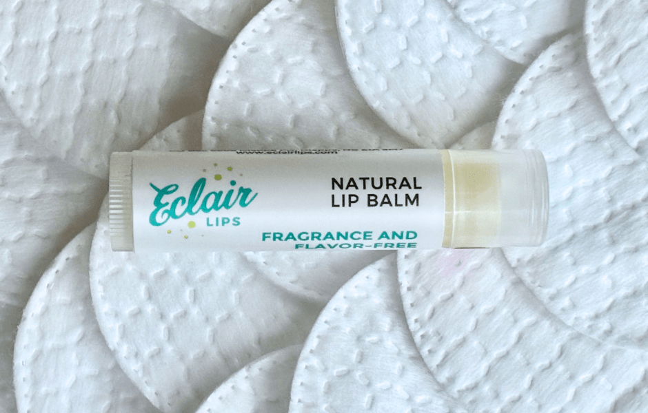 An Eclair Lips Fragrance Free Lip Balm on a background of cotton rounds