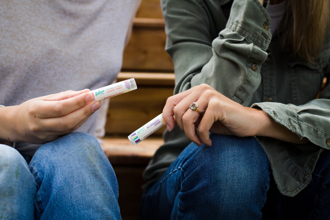two friends comparing tubes of lip balm