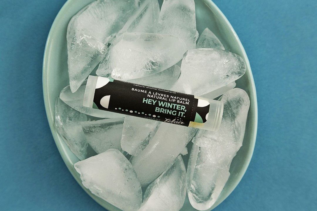 A tube of Eclair Lips Hey Winter Bring It lip balm on top of a small dish filled with ice